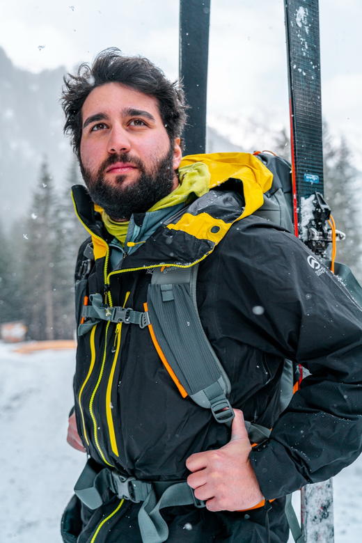Roberto Scottini con gli sci sulle spalle durante una nevicata